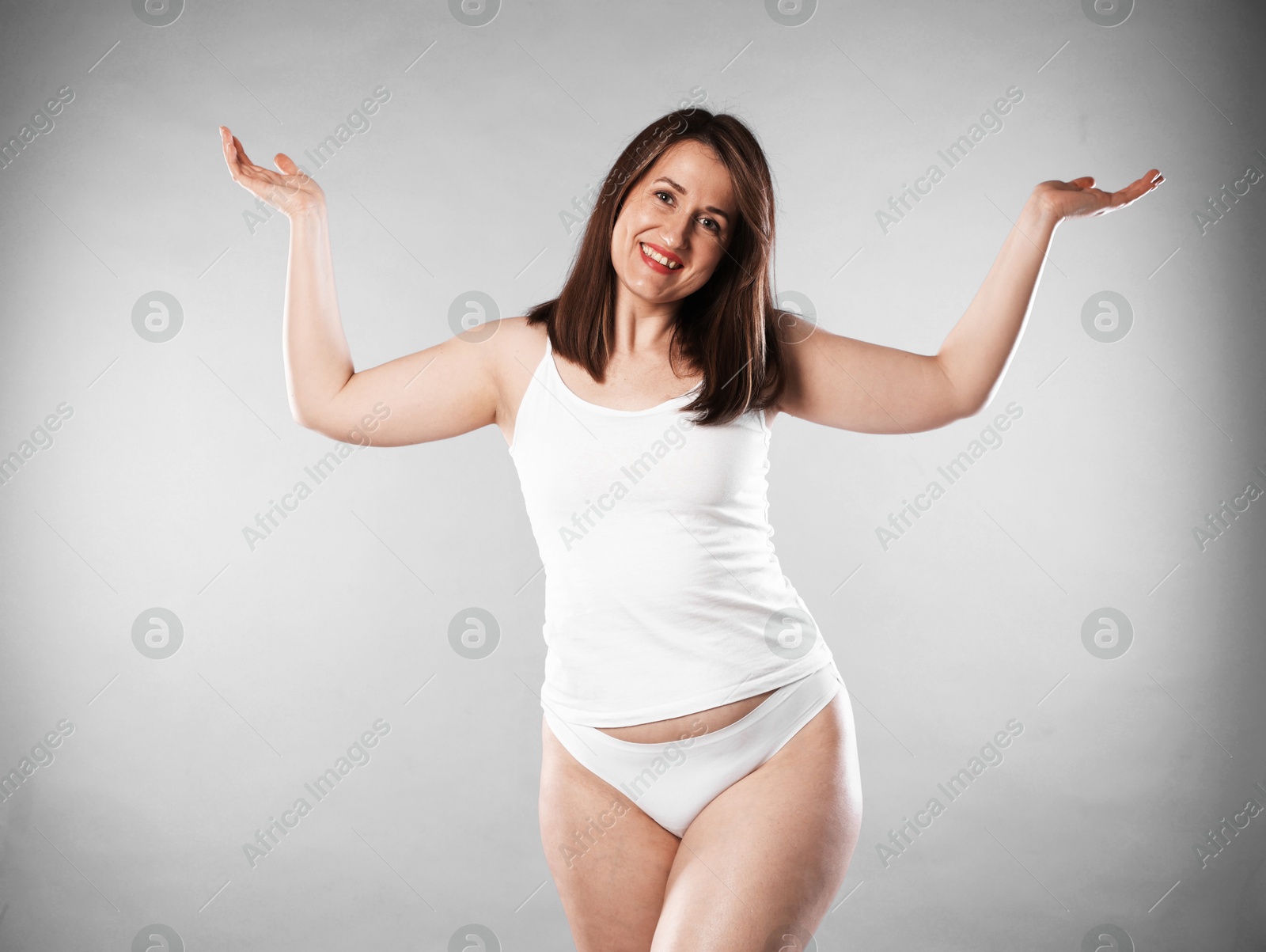 Photo of Woman in underwear on light grey background. Cellulite problem