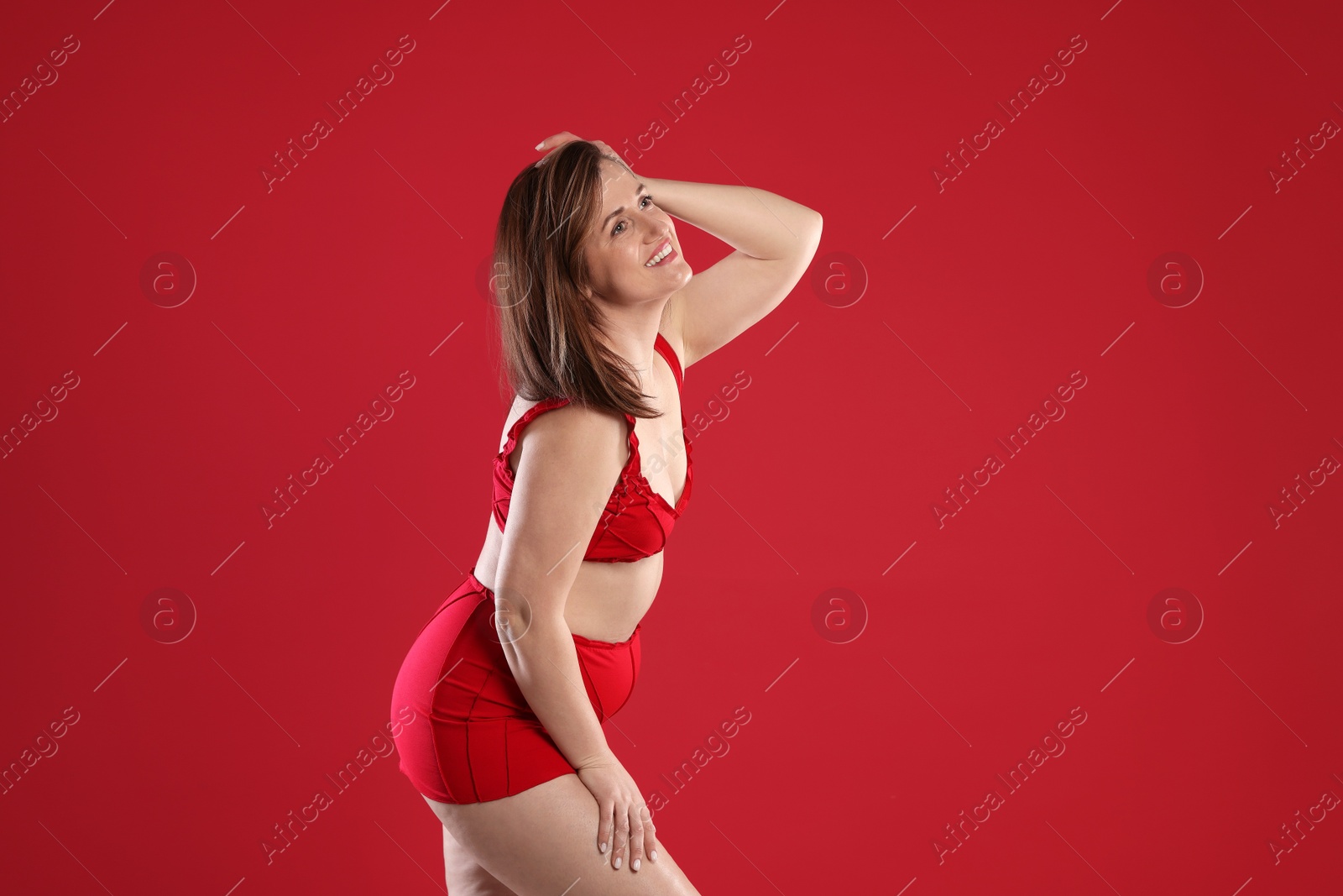 Photo of Woman in underwear on red background, space for text. Cellulite problem