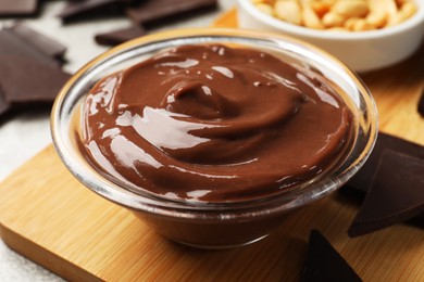 Delicious chocolate mousse in glass bowl on table, closeup