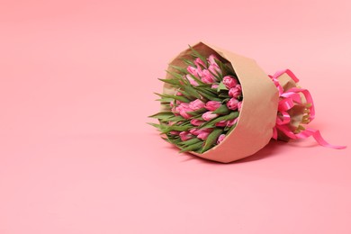 Photo of Bouquet of beautiful tulips on pink background, space for text