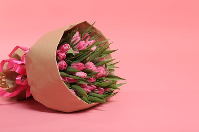 Photo of Bouquet of beautiful tulips on pink background, space for text