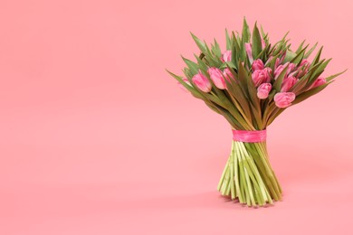 Bouquet of beautiful tulips on pink background, space for text