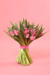 Bouquet of beautiful tulips on pink background