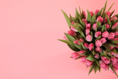 Bouquet of beautiful tulips on pink background, top view. Space for text