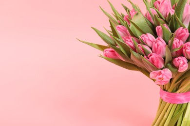 Photo of Bouquet of beautiful tulips on pink background, closeup. Space for text