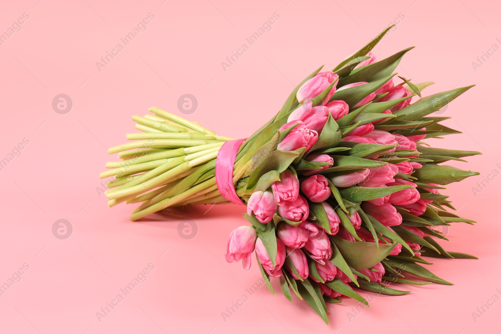 Photo of Bouquet of beautiful tulips on pink background