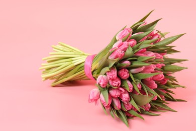 Bouquet of beautiful tulips on pink background