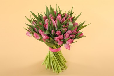 Bouquet of beautiful tulips on beige background