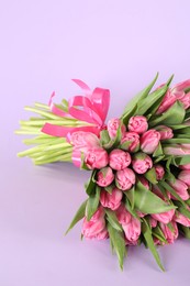 Photo of Bouquet of beautiful tulips on lilac background, closeup