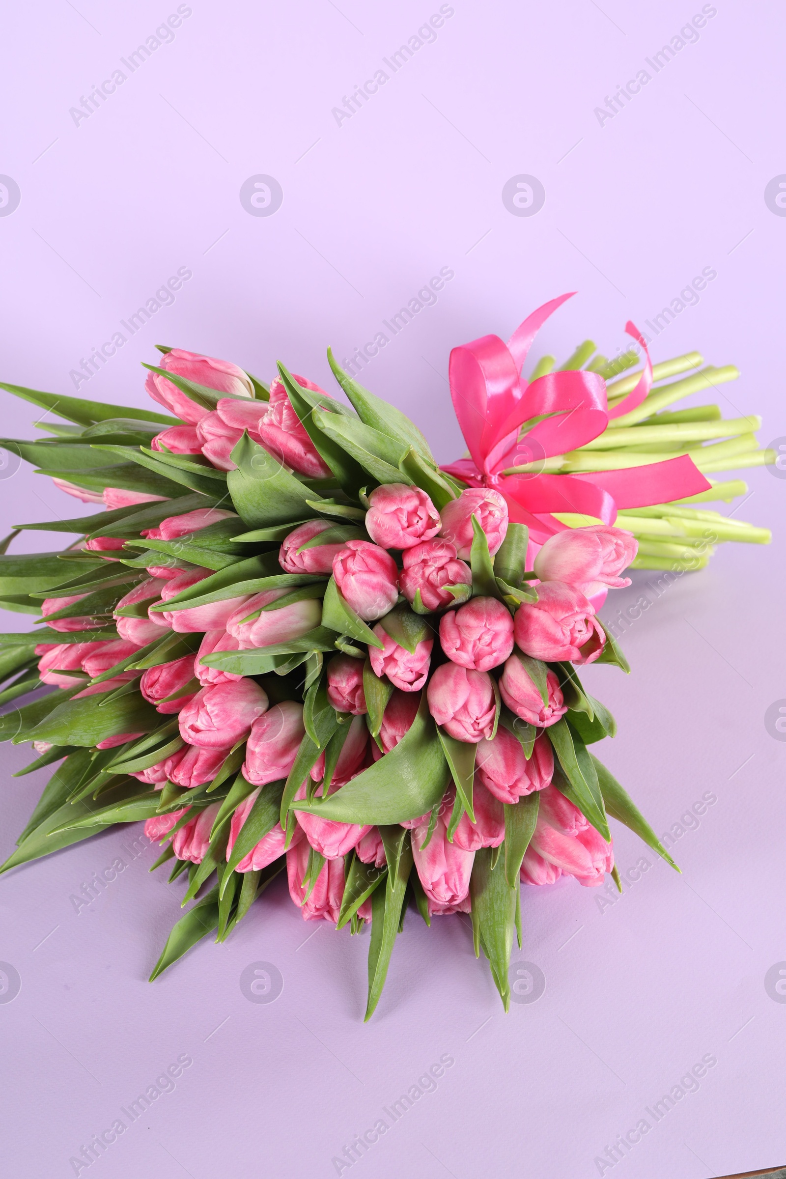 Photo of Bouquet of beautiful tulips on lilac background