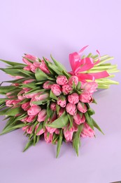 Photo of Bouquet of beautiful tulips on lilac background