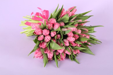 Bouquet of beautiful tulips on lilac background