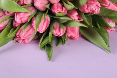 Photo of Bouquet of beautiful tulips on lilac background, closeup