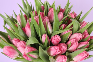 Photo of Bouquet of beautiful tulips on lilac background, closeup