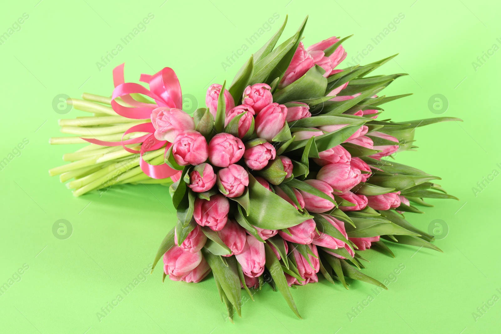 Photo of Bouquet of beautiful tulips on green background