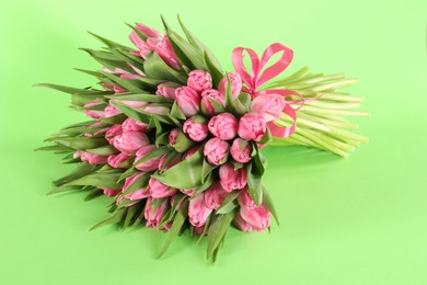 Bouquet of beautiful tulips on green background