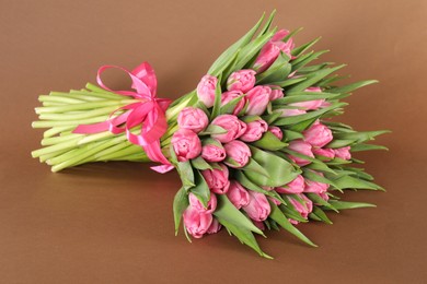 Bouquet of beautiful tulips on brown background