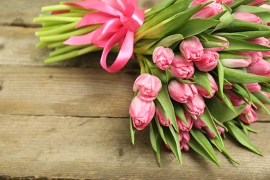 Bouquet of beautiful tulips on wooden table, closeup. Space for text