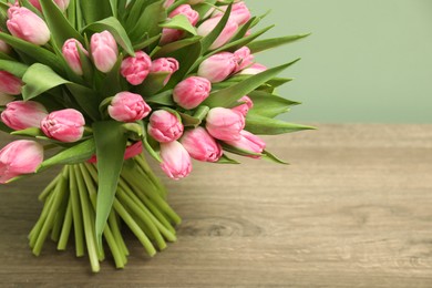 Bouquet of beautiful tulips on wooden table, closeup. Space for text