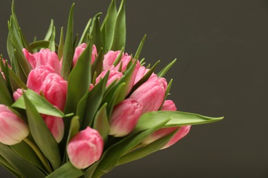 Photo of Bouquet of beautiful tulips on grey background, closeup