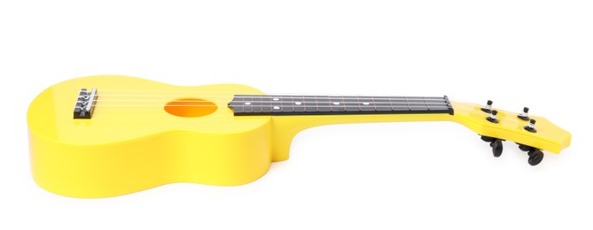 Photo of Yellow toy guitar isolated on white. Child's musical instrument