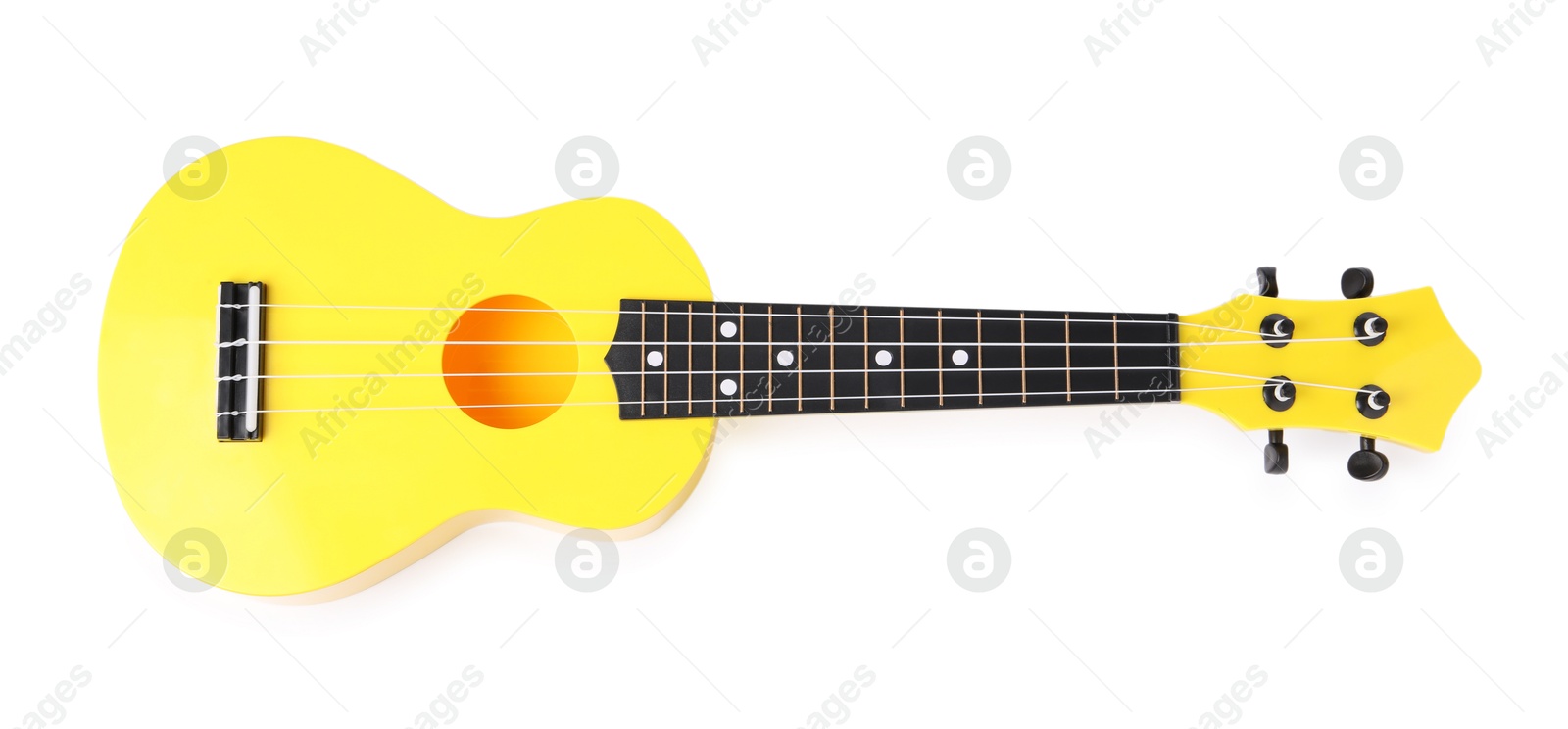 Photo of Yellow toy guitar isolated on white, top view. Child's musical instrument