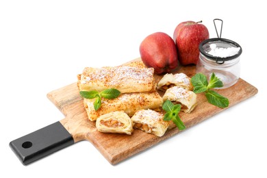 Photo of Tasty apple strudels with powdered sugar, fruits and mint isolated on white