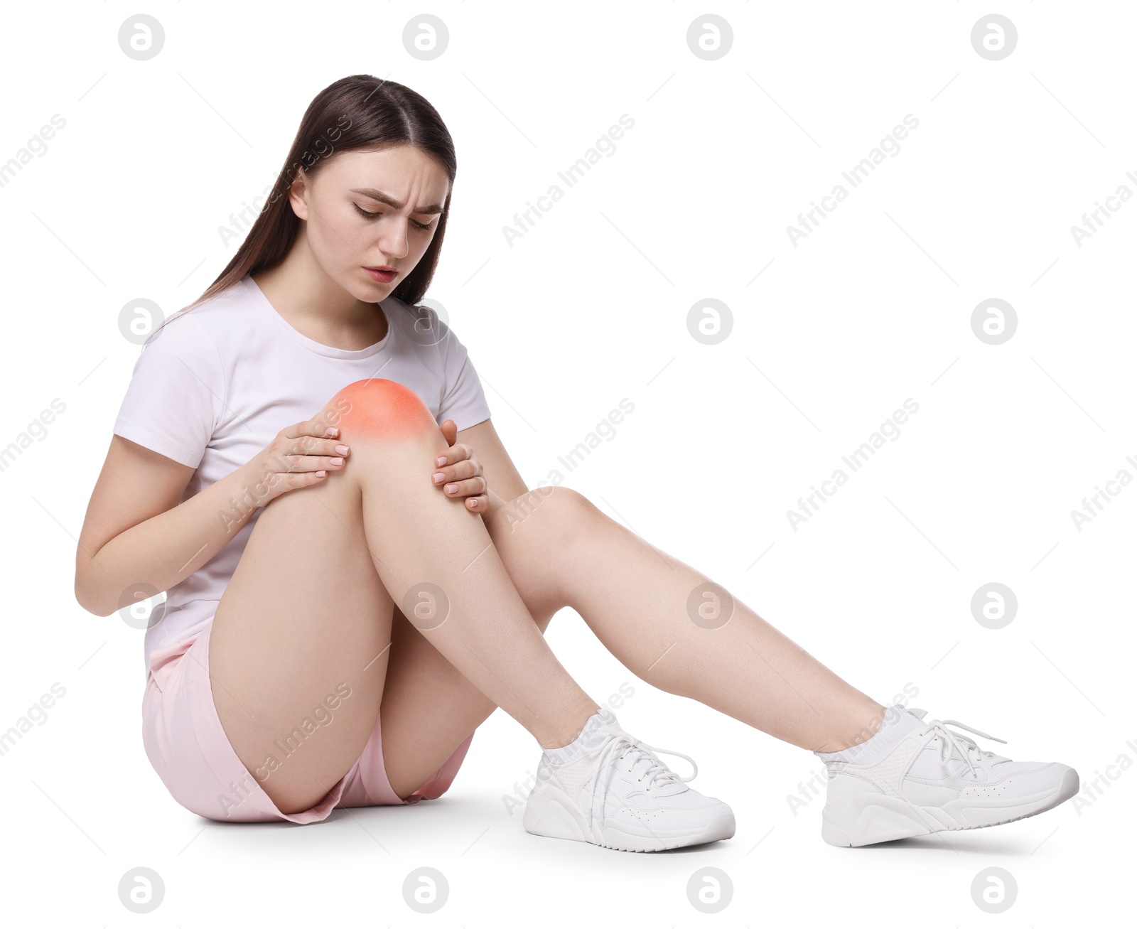 Image of Young woman suffering from pain in knee on white background