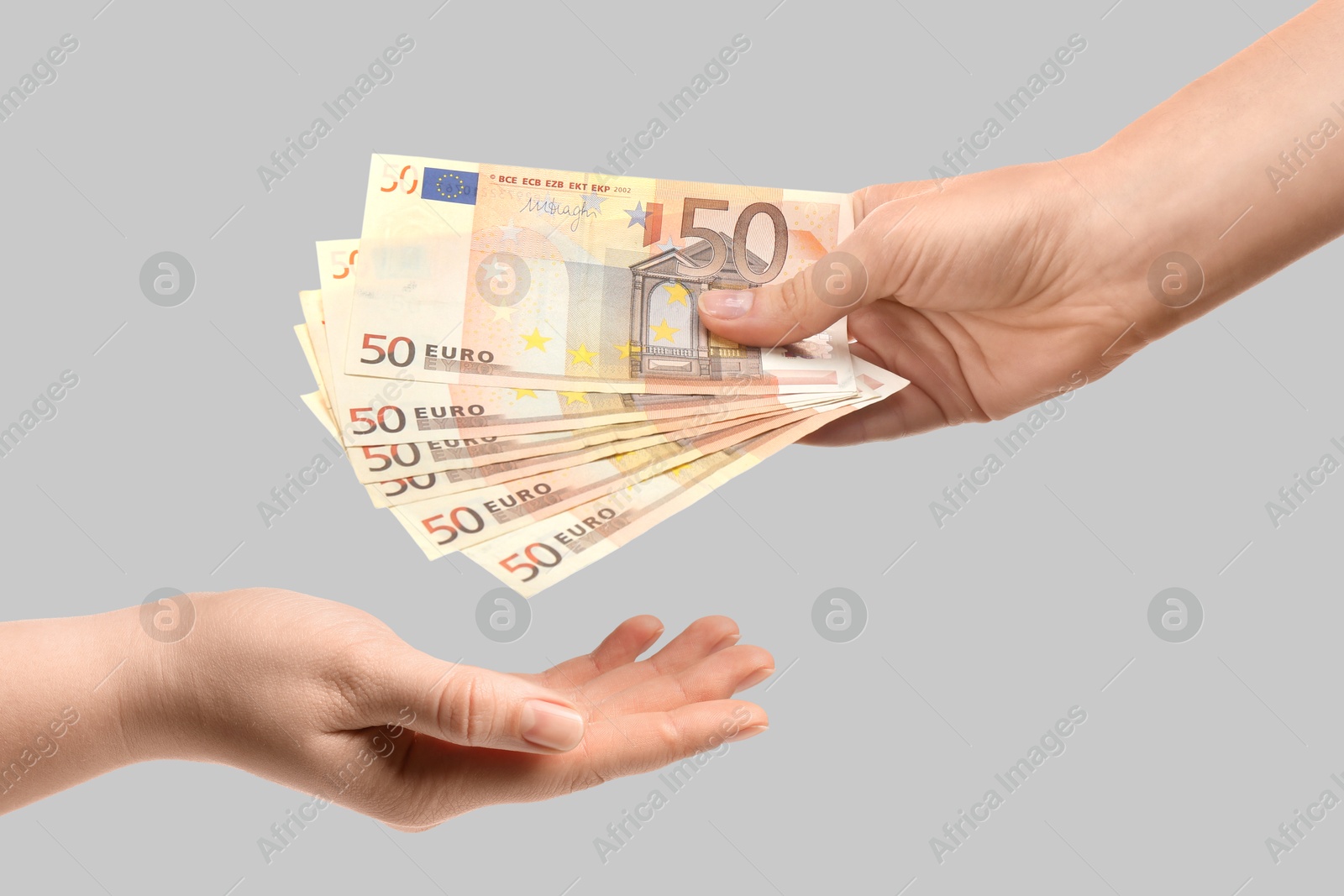 Image of Sponsor giving euro banknotes to woman on grey background, closeup