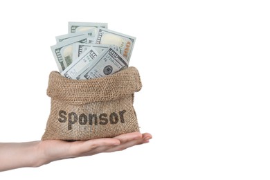 Image of Woman holding sack with word Sponsor full of dollar banknotes on white background, closeup