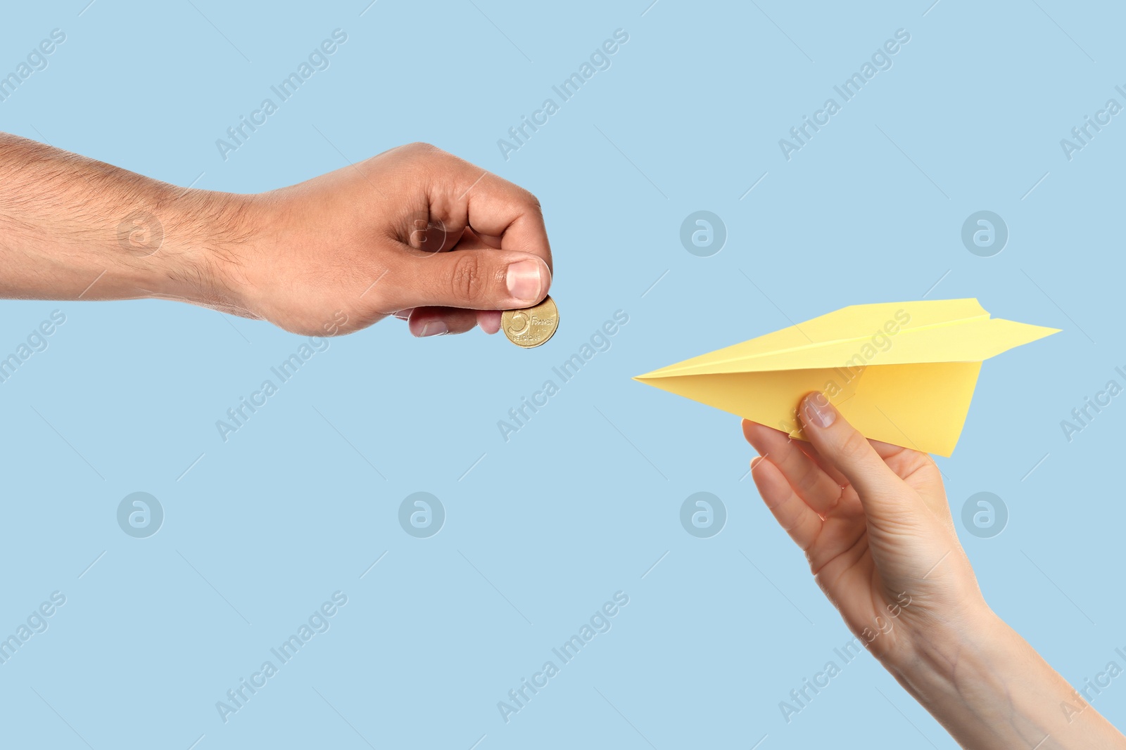 Image of Find sponsor. Man offering coin to woman with paper plane on light blue background, closeup