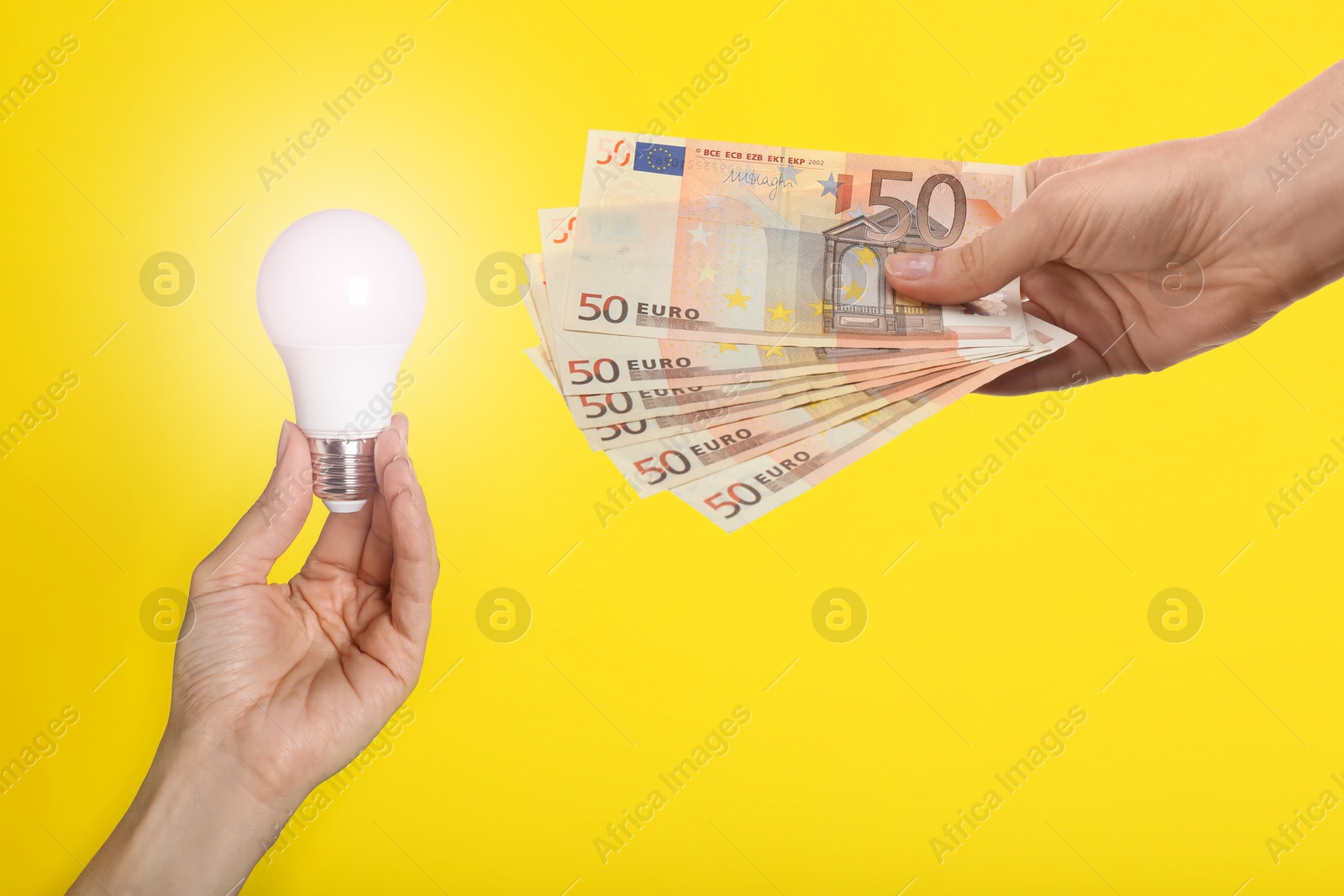 Image of Sponsor offering euro banknotes to woman with glowing light bulb on yellow background, closeup. Sponsorship of idea