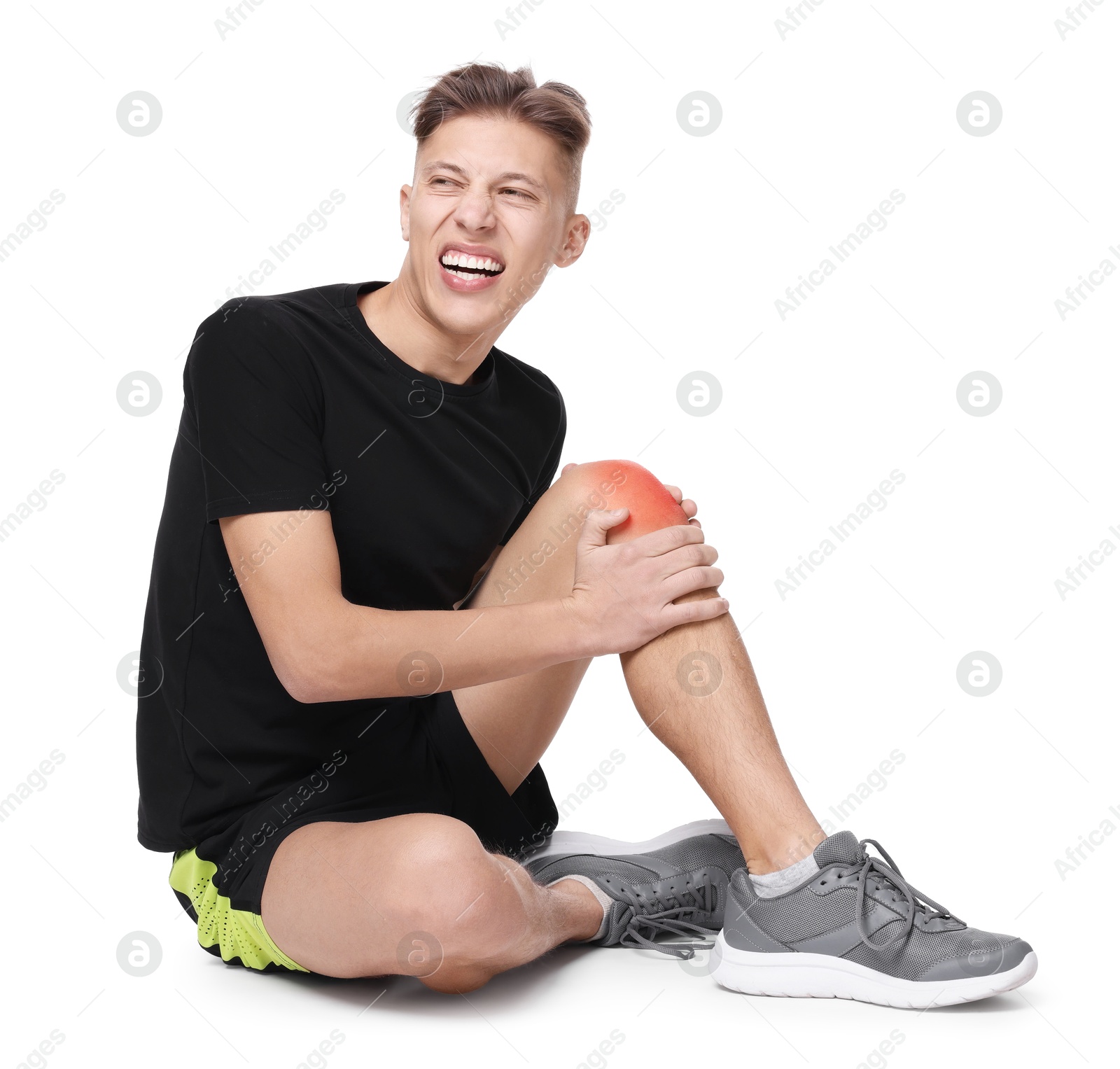 Image of Young man suffering from pain in knee on white background