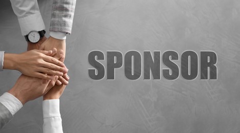 Sponsor. People holding hands together over grey stone background, top view. Banner design