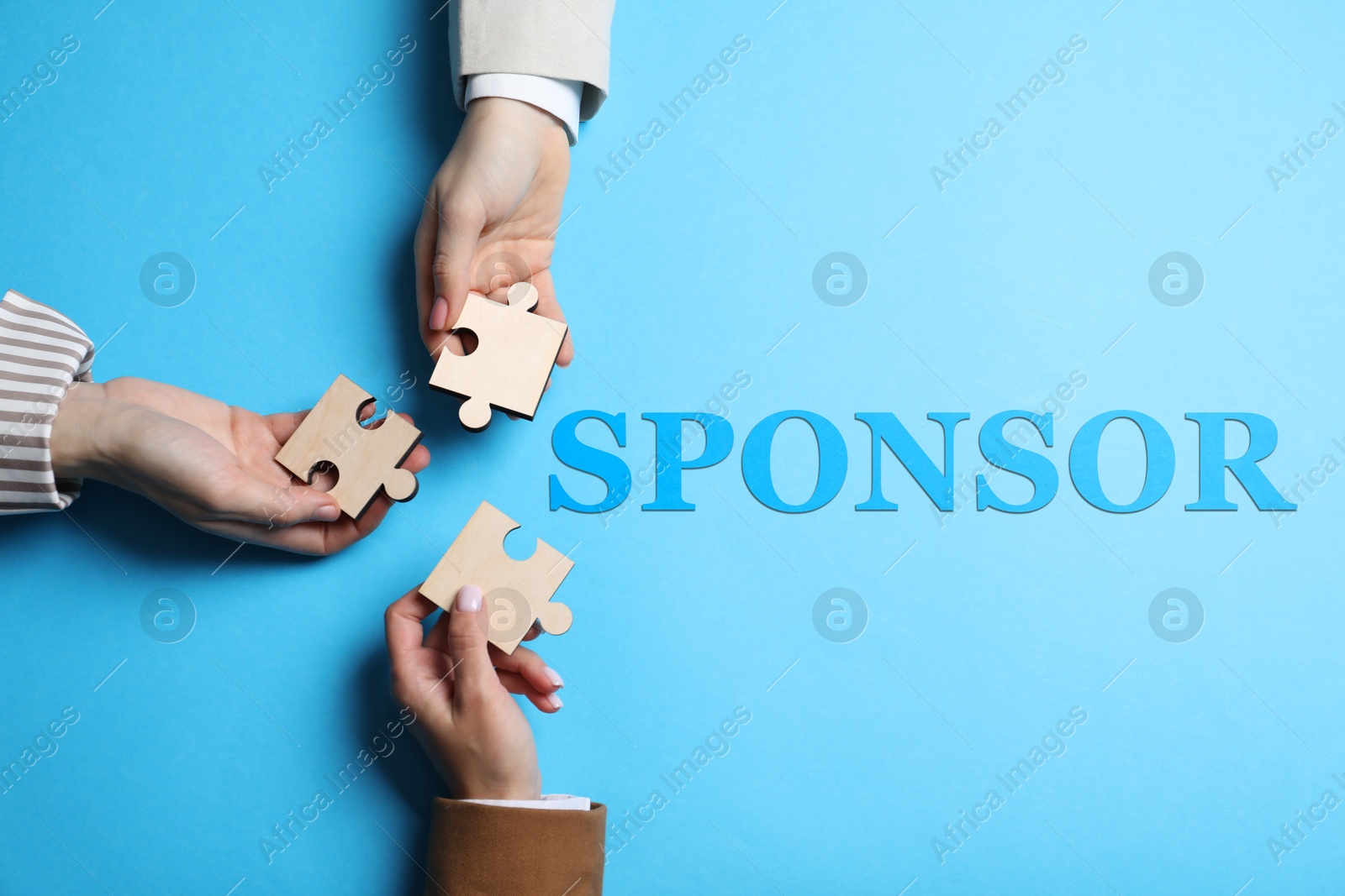 Image of Sponsor. People with jigsaw puzzle pieces on light blue background, top view