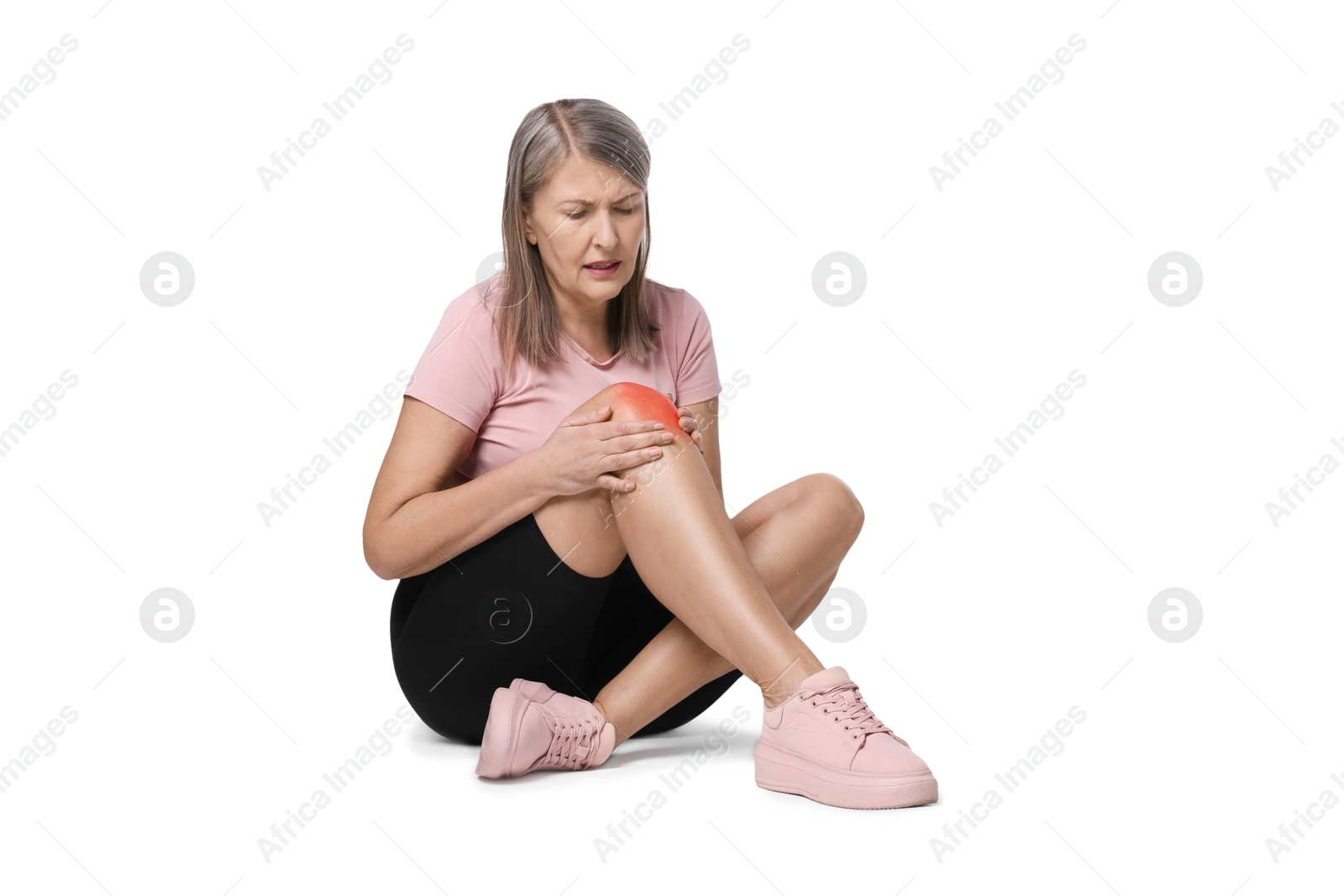 Image of Senior woman suffering from pain in knee on white background