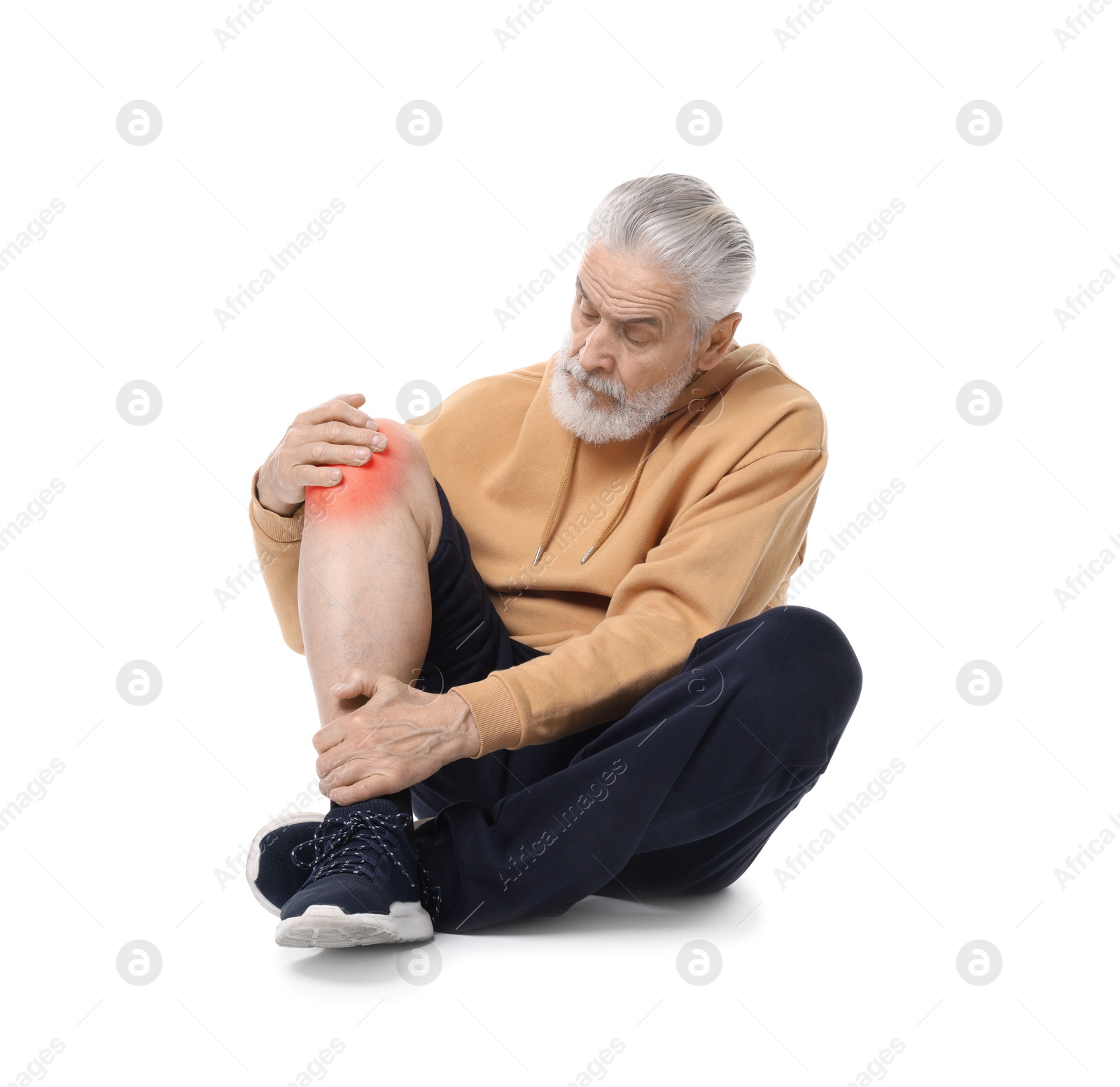 Image of Senior man suffering from pain in knee on white background