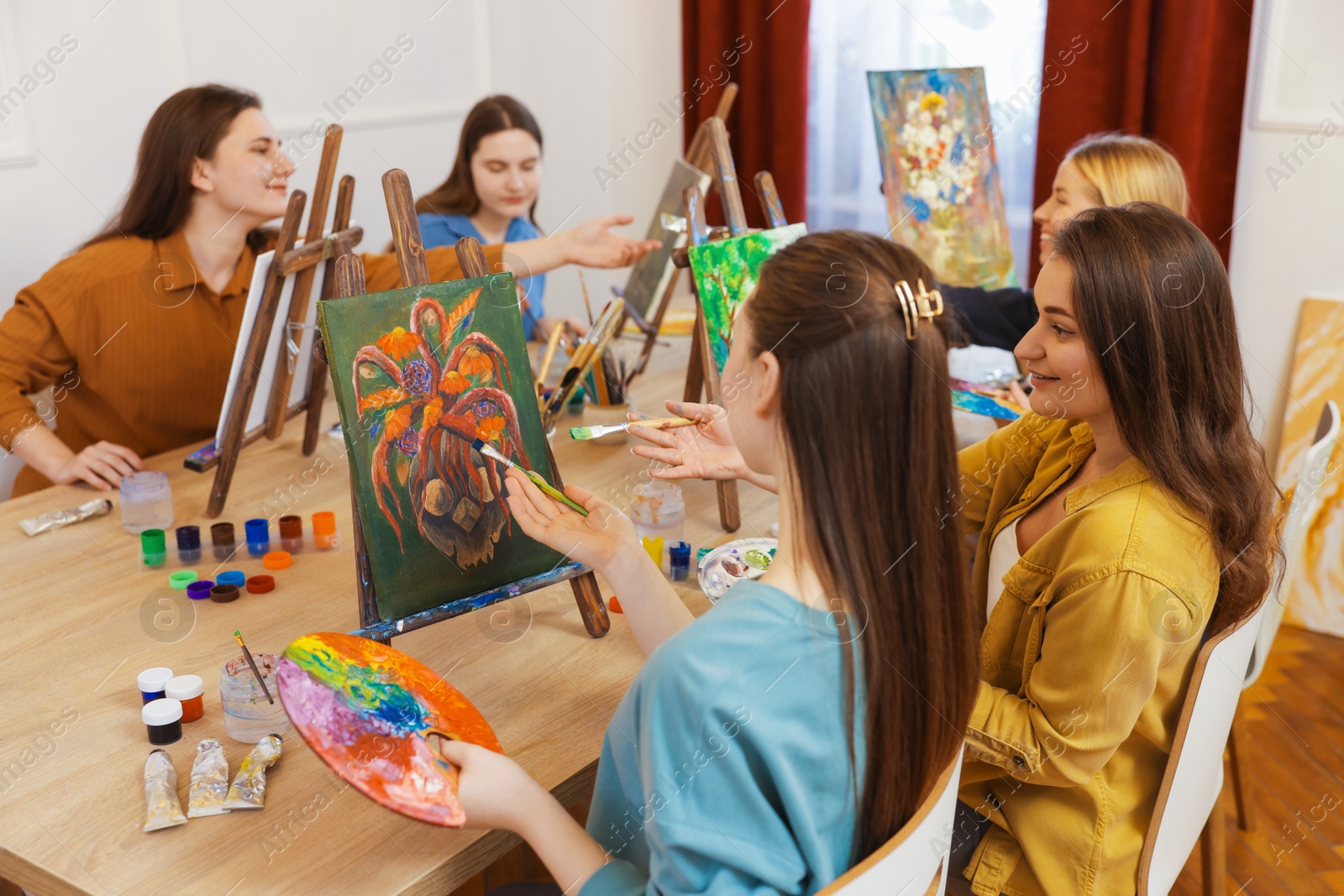 Photo of Group of women learning to draw at table in class