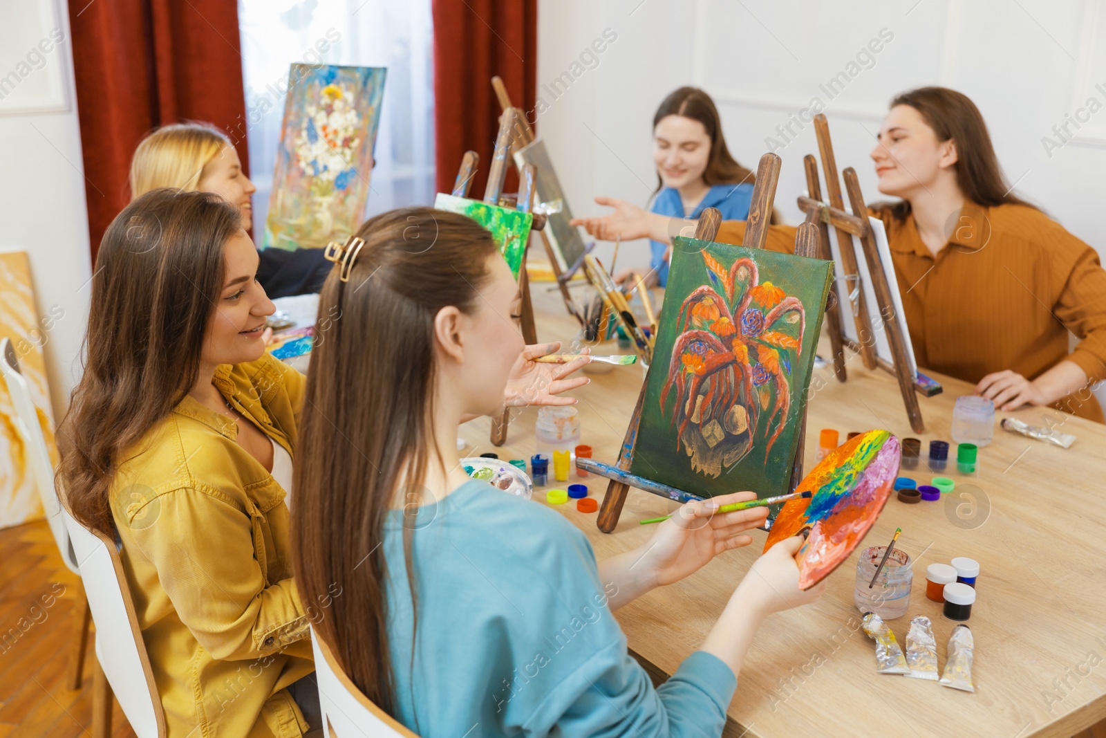 Photo of Group of women learning to draw at table in class