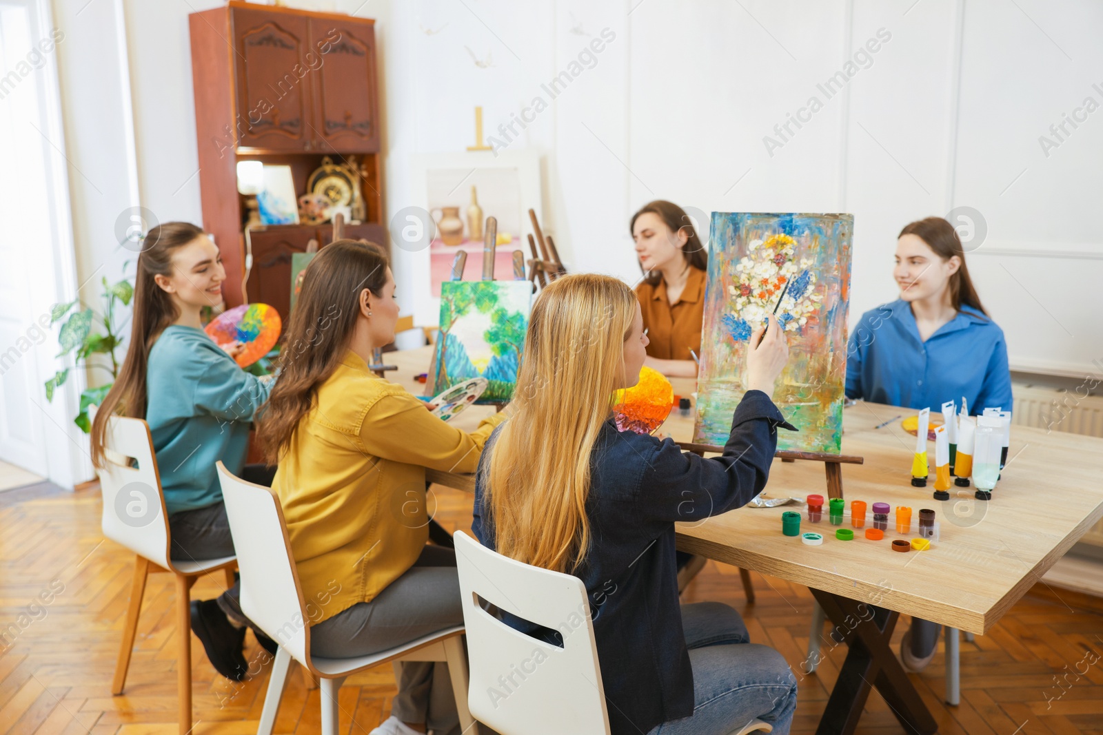 Photo of Group of women learning to draw at table in class