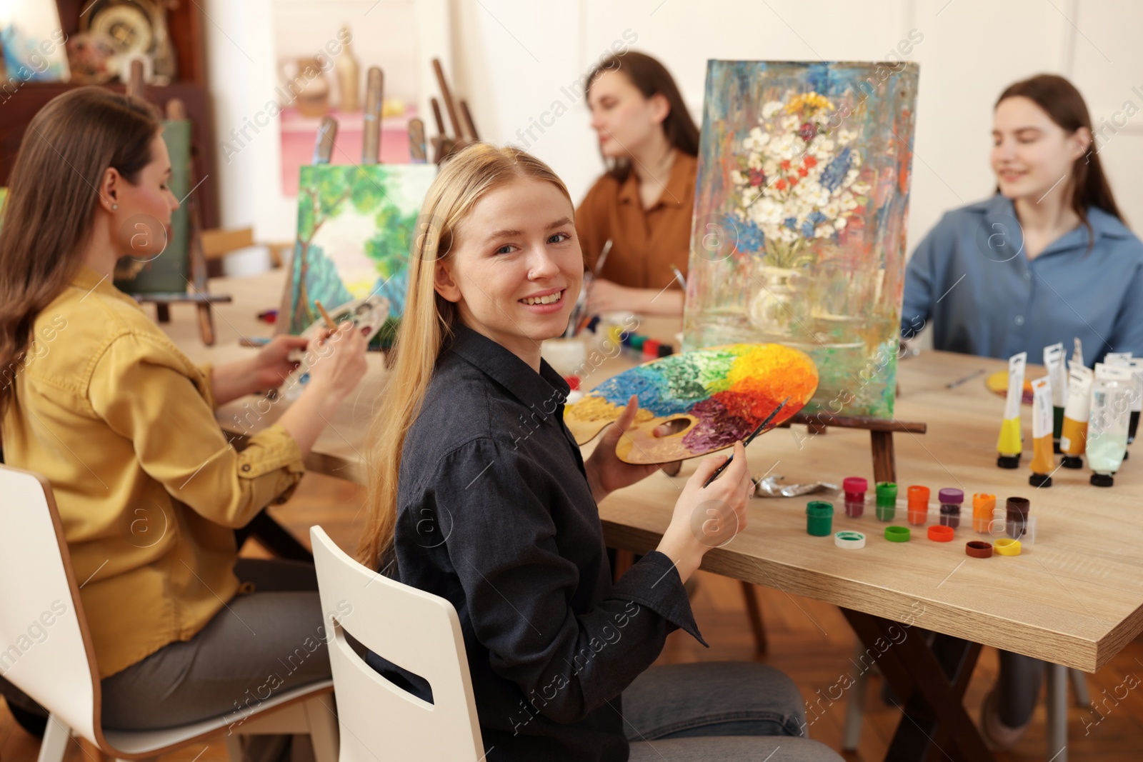 Photo of Group of women learning to draw at table in class