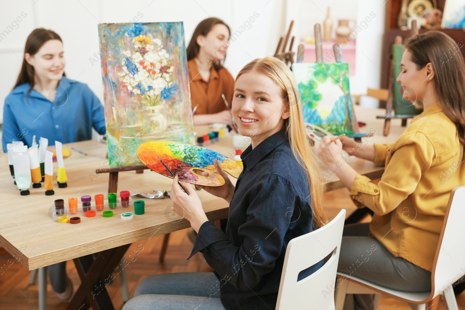 Photo of Group of women learning to draw at table in class