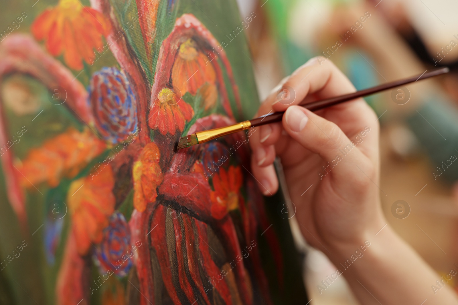 Photo of Woman learning to draw with brush on blurred background, closeup