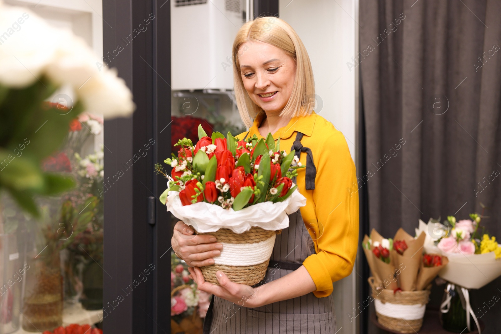 Photo of Business owner with beautiful bouquet in her flower shop