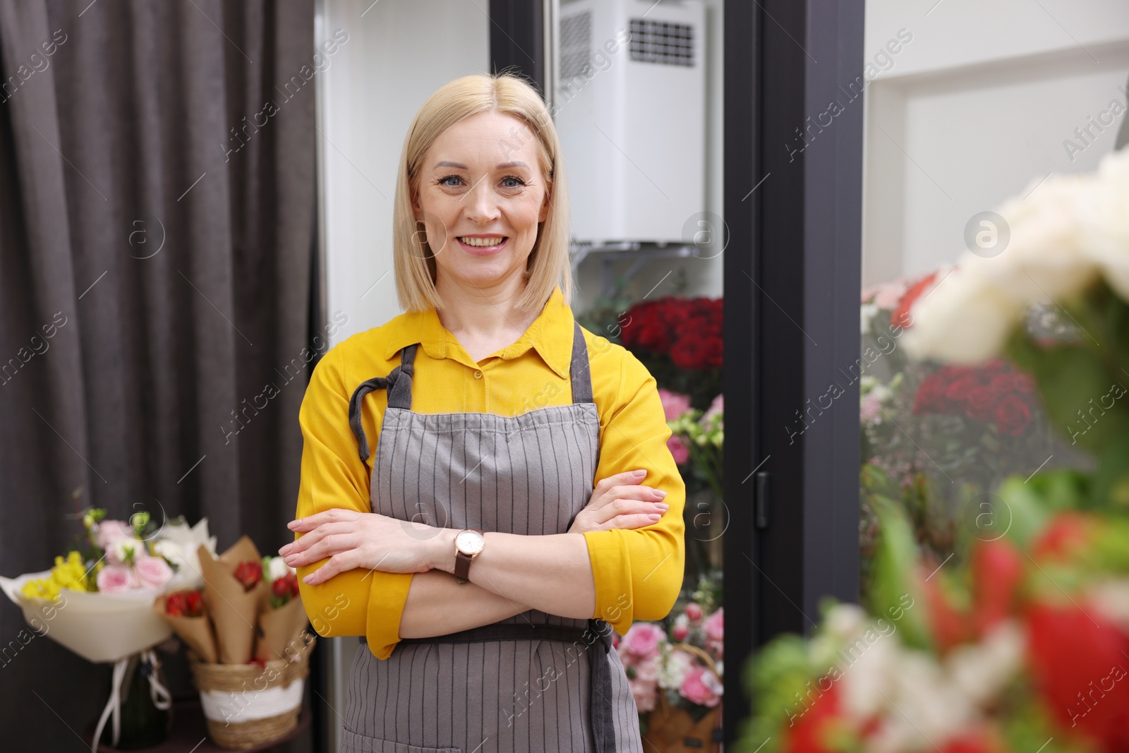 Photo of Business owner with crossed arms in her flower shop