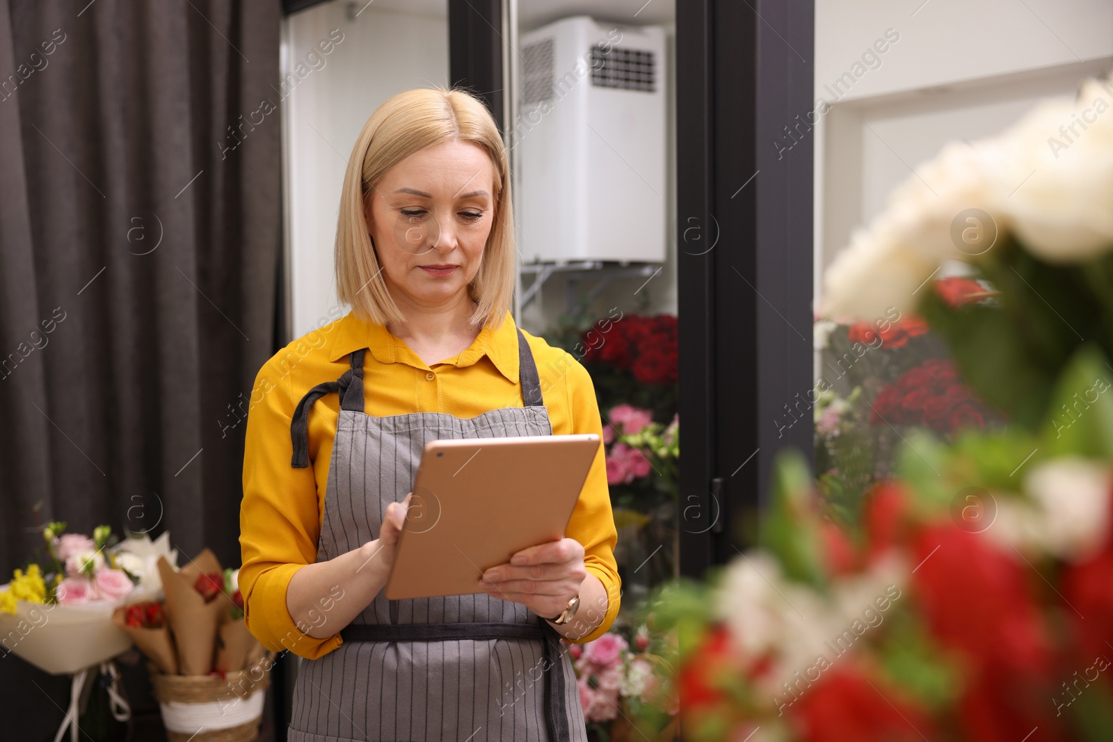 Photo of Business owner with tablet in her flower shop