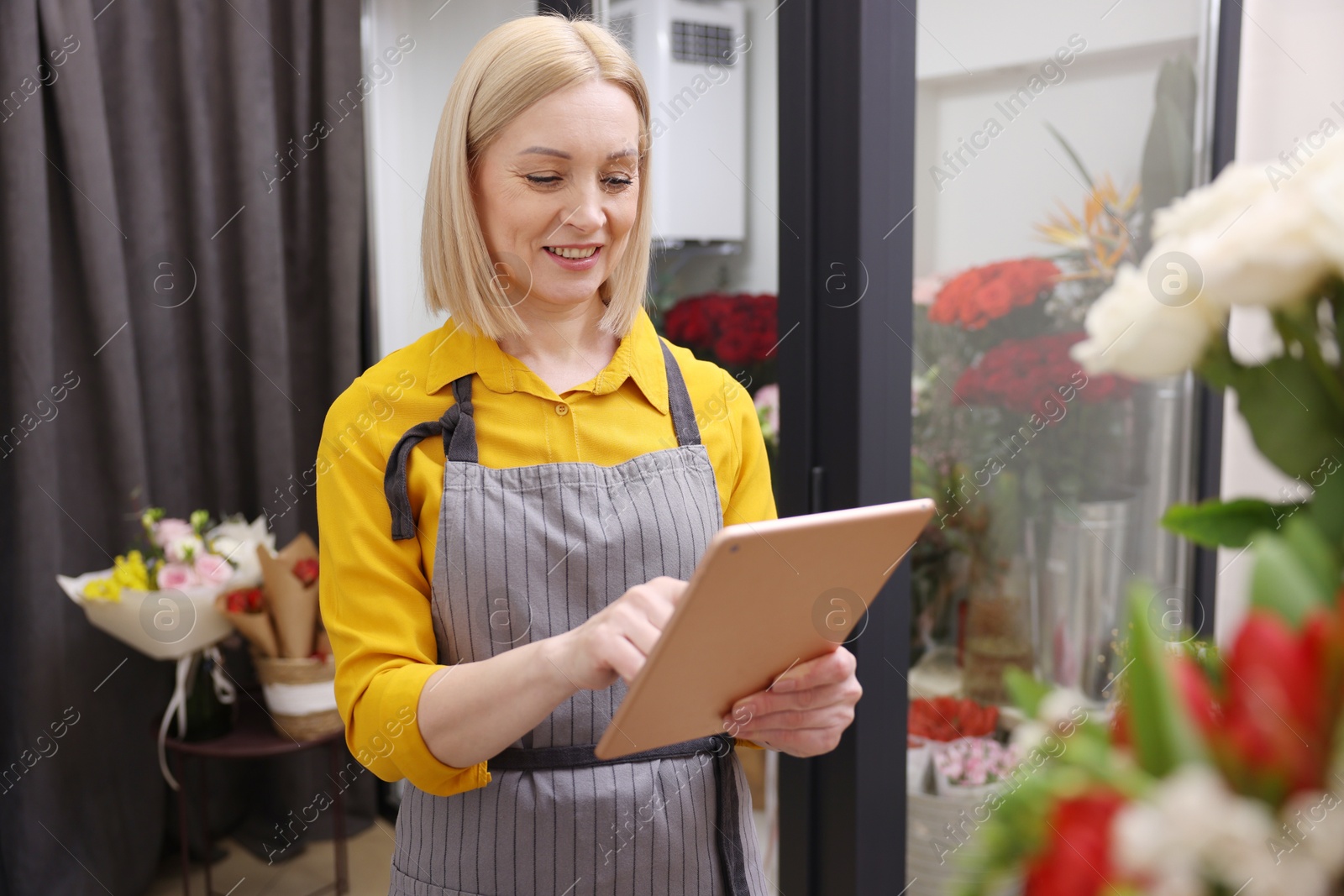 Photo of Business owner with tablet in her flower shop