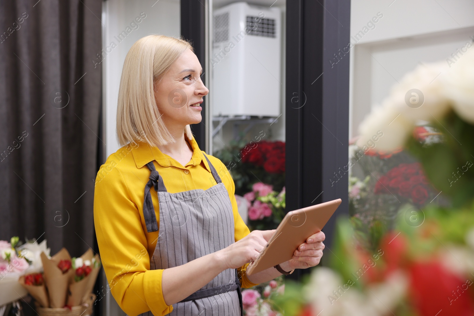 Photo of Business owner with tablet in her flower shop