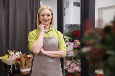 Happy business owner in her flower shop