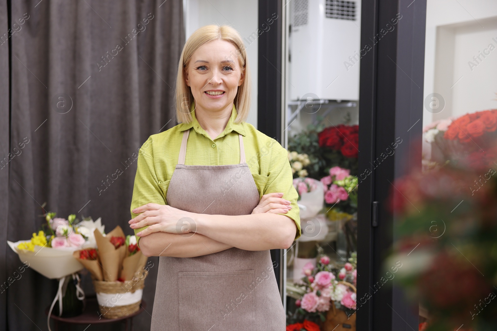 Photo of Business owner with crossed arms in her flower shop